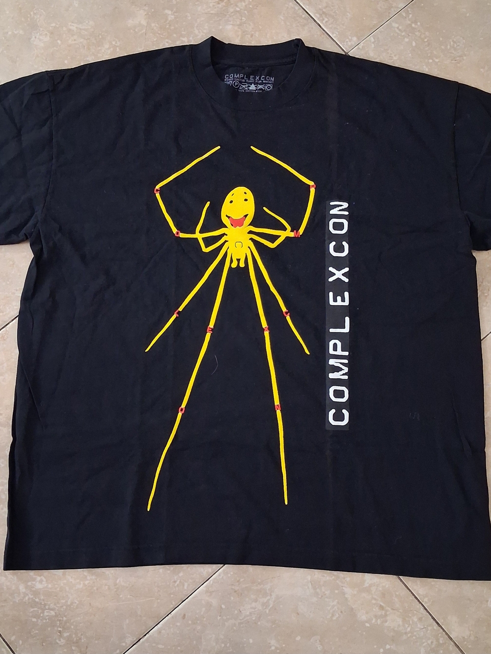 Cactus Plant Flea Market Complexcon Tee with Yellow Spider Graphic
